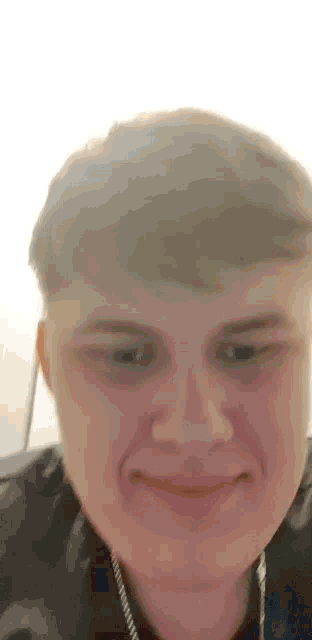 a close up of a young man making a funny face .