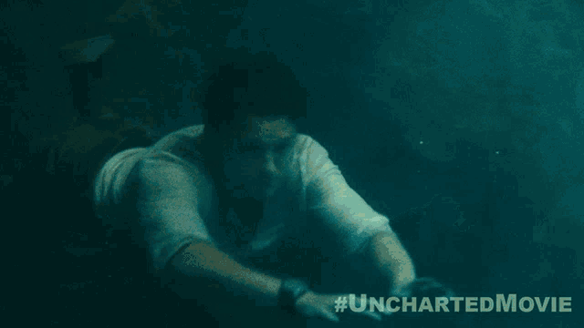 a man is swimming in the water with the hashtag #uncharteredmovie