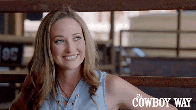 a woman is smiling in front of the cowboy way logo