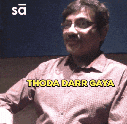 a man with glasses says thoda darr gaya in yellow letters