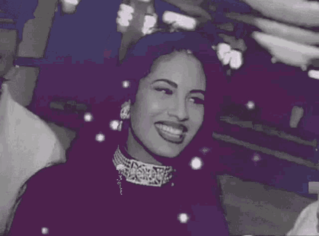 a black and white photo of a woman wearing a choker