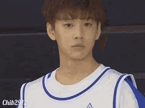 a young man wearing a white and blue basketball jersey with the name chib2912 on the bottom