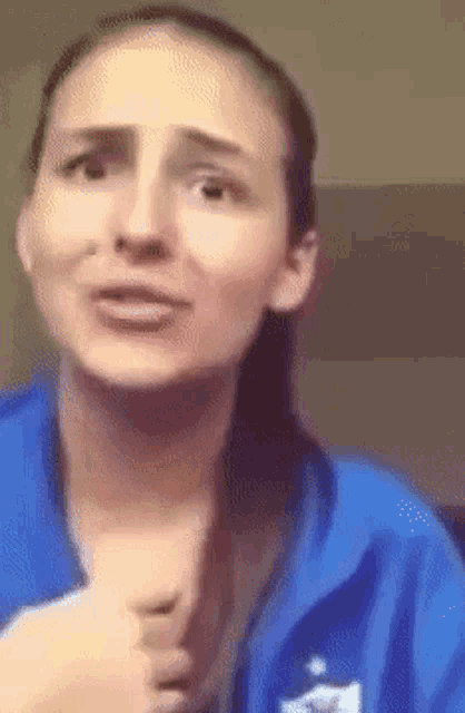 a woman wearing a blue sweatshirt with a cat on the front