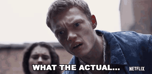 a man in a denim jacket is saying what the actual