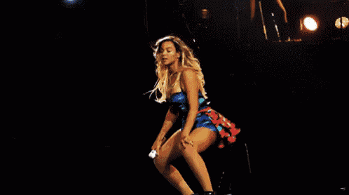 a woman in a blue and red dress is dancing on stage