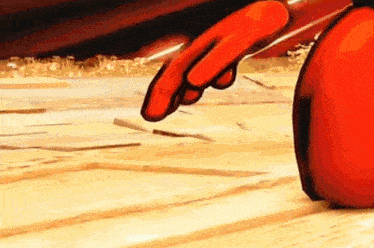 a close up of a cartoon character 's hand reaching out towards something .