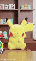 a yellow pikachu stuffed animal is sitting on a table
