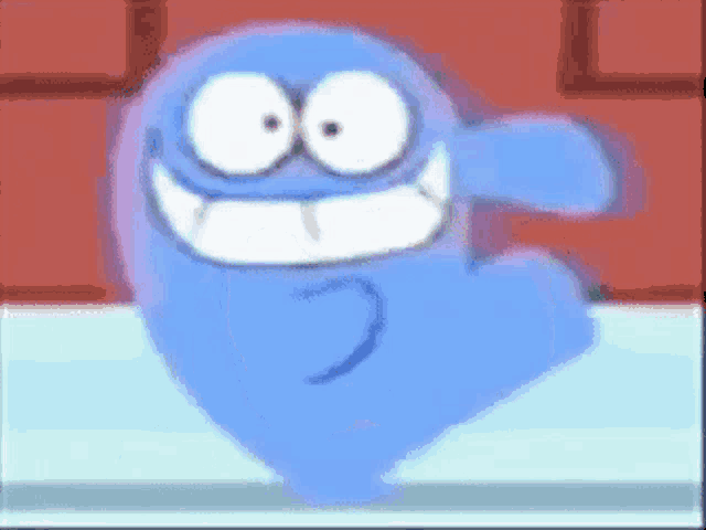 a blue cartoon character is dancing and smiling in front of a red brick wall .