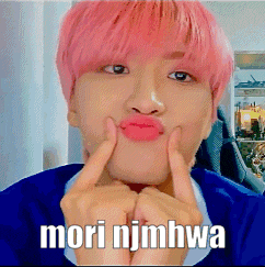 a young man with pink hair is making a face with his fingers and the words mori njmhwa written on the bottom