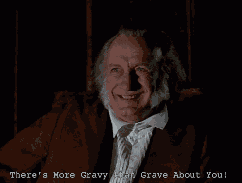 a man in a dark room with the words there 's more gravy than grave about you