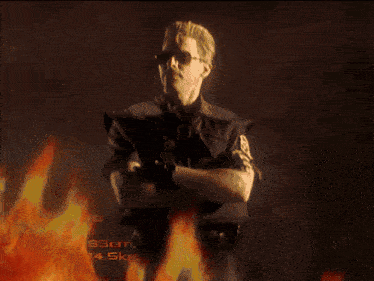 a painting of a man surrounded by flames with the letter m visible