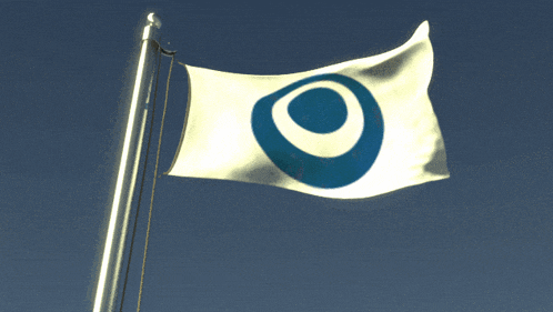 a white flag with a blue circle in the middle is waving in the wind