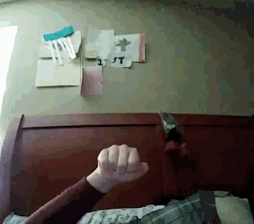 a person 's fist is raised in the air in front of a wall with papers on it that say " lost "