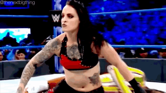 a pixelated image of a woman in a wrestling ring with the nextbigthing written on the bottom right