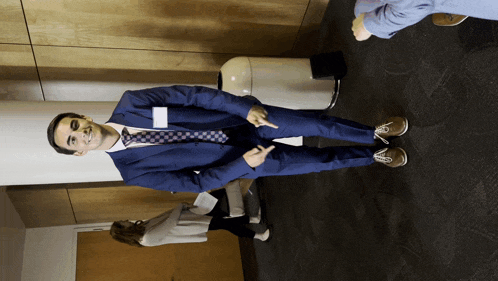 a man in a blue suit has a name tag on his sleeve