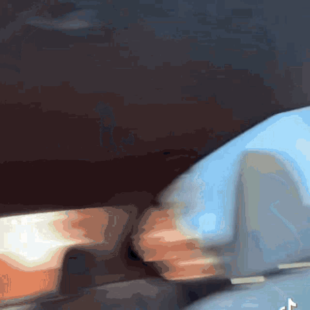 a blurred image of a person 's arm with a t on the bottom right