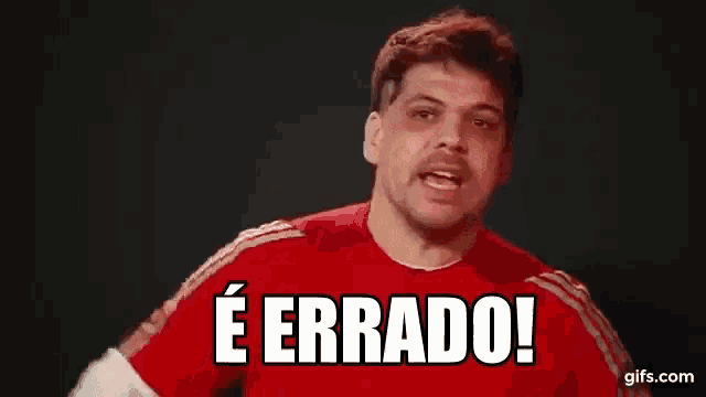 a man in a red shirt is making a funny face and saying e errado .