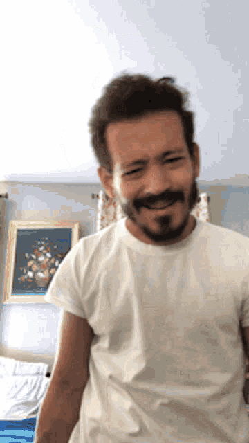 a man with a beard wearing a white shirt