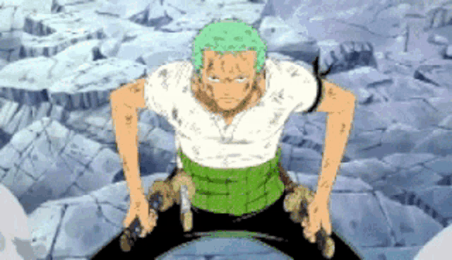 a man with green hair and a white shirt is kneeling down in front of a pile of rocks .