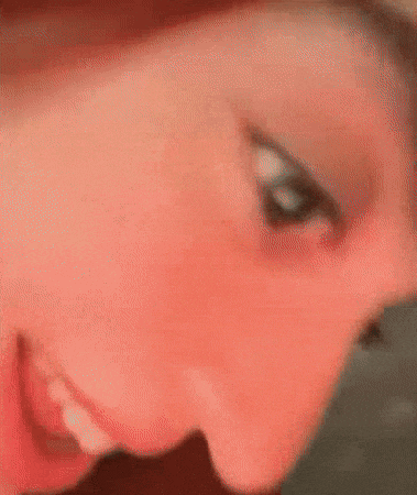 a blurry picture of a woman with red hair making a face .