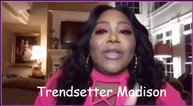 a woman in a pink shirt is talking on a video call with the name trendsetter madison written on the bottom
