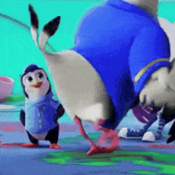 two penguins are standing next to each other on a blue surface .