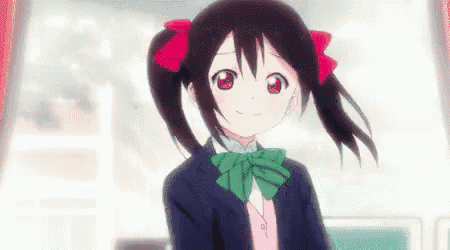 a girl with two ponytails and a green bow tie is smiling .