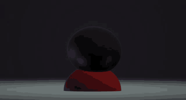 a black egg with purple eyes sits on a red base in the dark