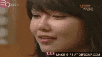 a close up of a woman 's face with a make gifs at gifsoup.com logo in the corner .