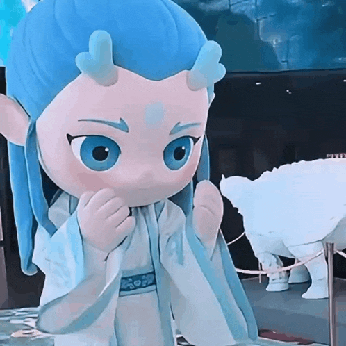 a cartoon character with blue hair and horns is standing next to a statue of a bear .
