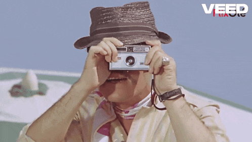 a man with glasses and a mustache says un moment please