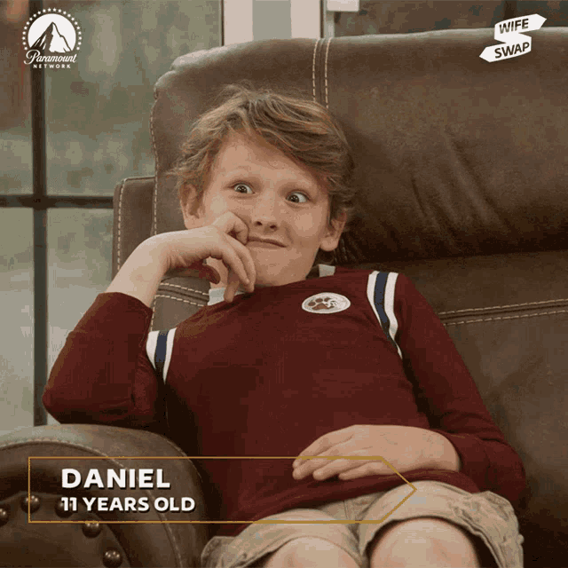 a young boy is sitting on a couch with wife swap written on the bottom