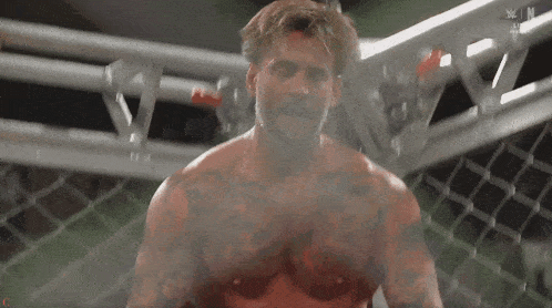 a man in a boxing ring is covered in blood and smoke