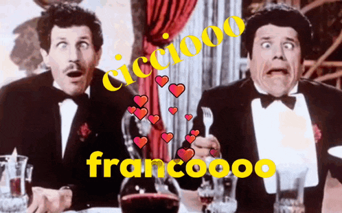 two men in tuxedos are sitting at a table with hearts surrounding them and the word francooo in yellow