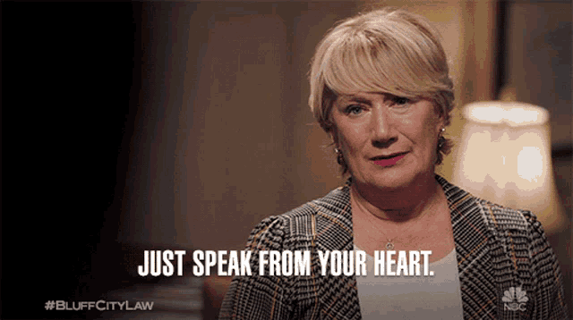 a woman says " just speak from your heart " while holding a piece of paper in her hand