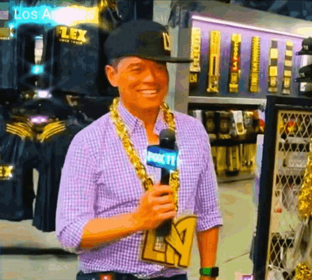 a man wearing a hat and a fox tv microphone