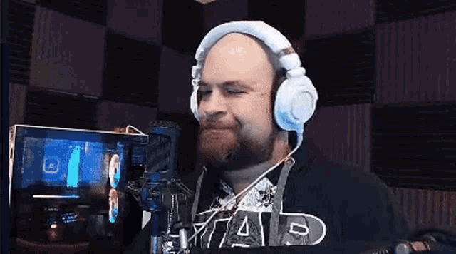 a man wearing headphones and a star wars shirt is smiling