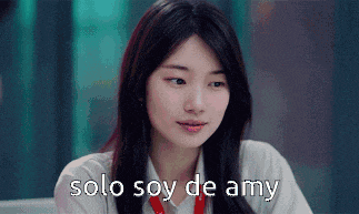 a woman sitting at a table with the words solo soy de amy written on her face .