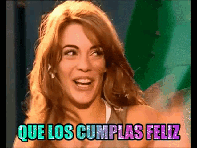a woman is smiling with the words que los cumplas feliz in the background