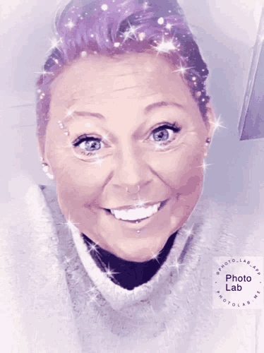 a woman with purple hair is smiling with a photo lab logo in the corner