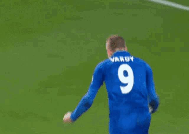 a soccer player with the number 9 on his jersey kneeling on the field