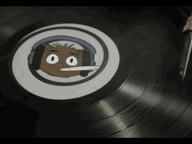 a record with a sticker of a cat wearing headphones