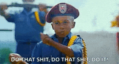 a young boy in a military uniform is holding a gun and saying `` do that shit do that shit do it ! ''