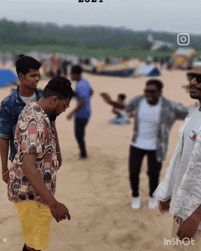 a group of men standing on a sandy beach with the year 2021 on the bottom