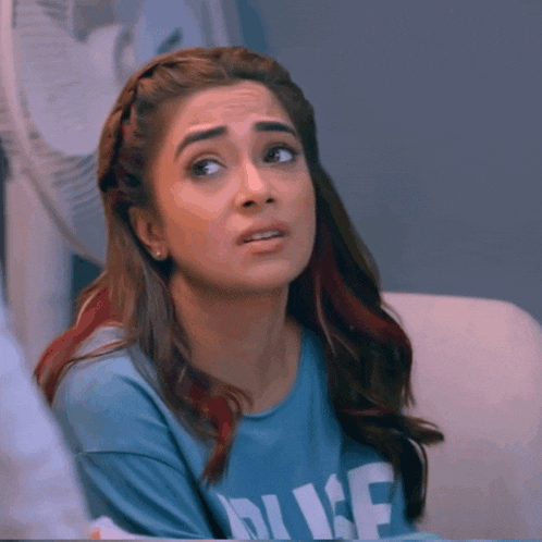 a woman wearing a blue shirt that says duke on it