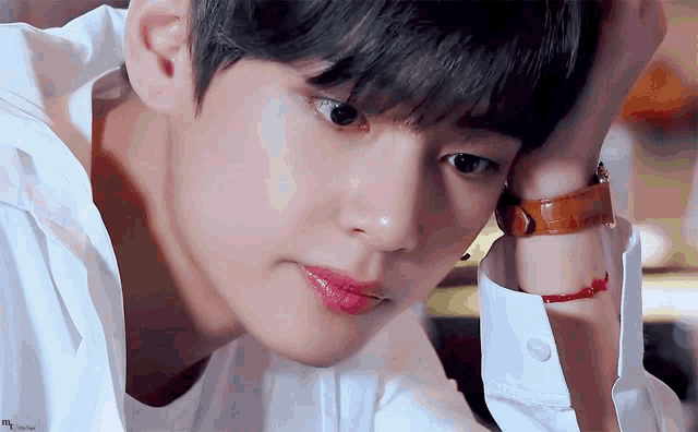 a close up of a young man wearing a watch