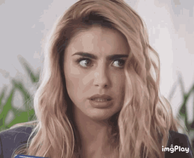 a close up of a woman 's face with the word imgplay visible