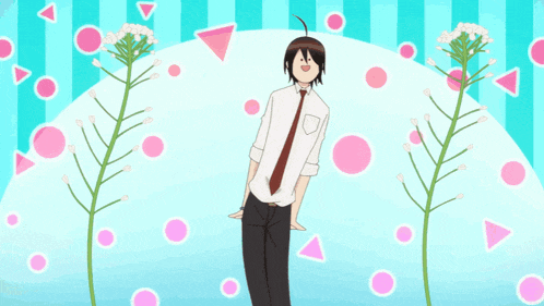 a man in a tie is standing in front of flowers