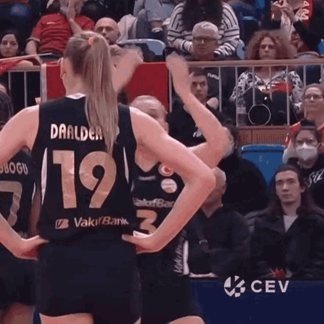 two female basketball players are standing next to each other and one has the number 19 on her jersey