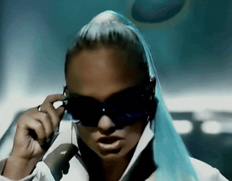 a woman with blue hair is wearing sunglasses and talking on a phone